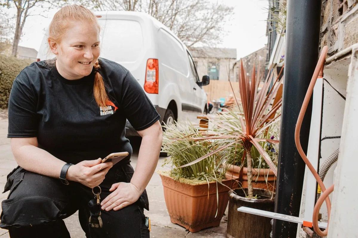 Fay Dolphin of Dolphin Heating, a Gas Safe registered engineer in Huddersfield, at work on a boiler